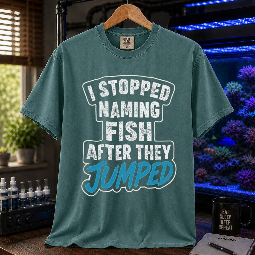 Saltwater aquarium graphic t-shirt featuring distressed block text and blue script: I STOPPED NAMING FISH AFTER THEY JUMPED, green crew neck tee