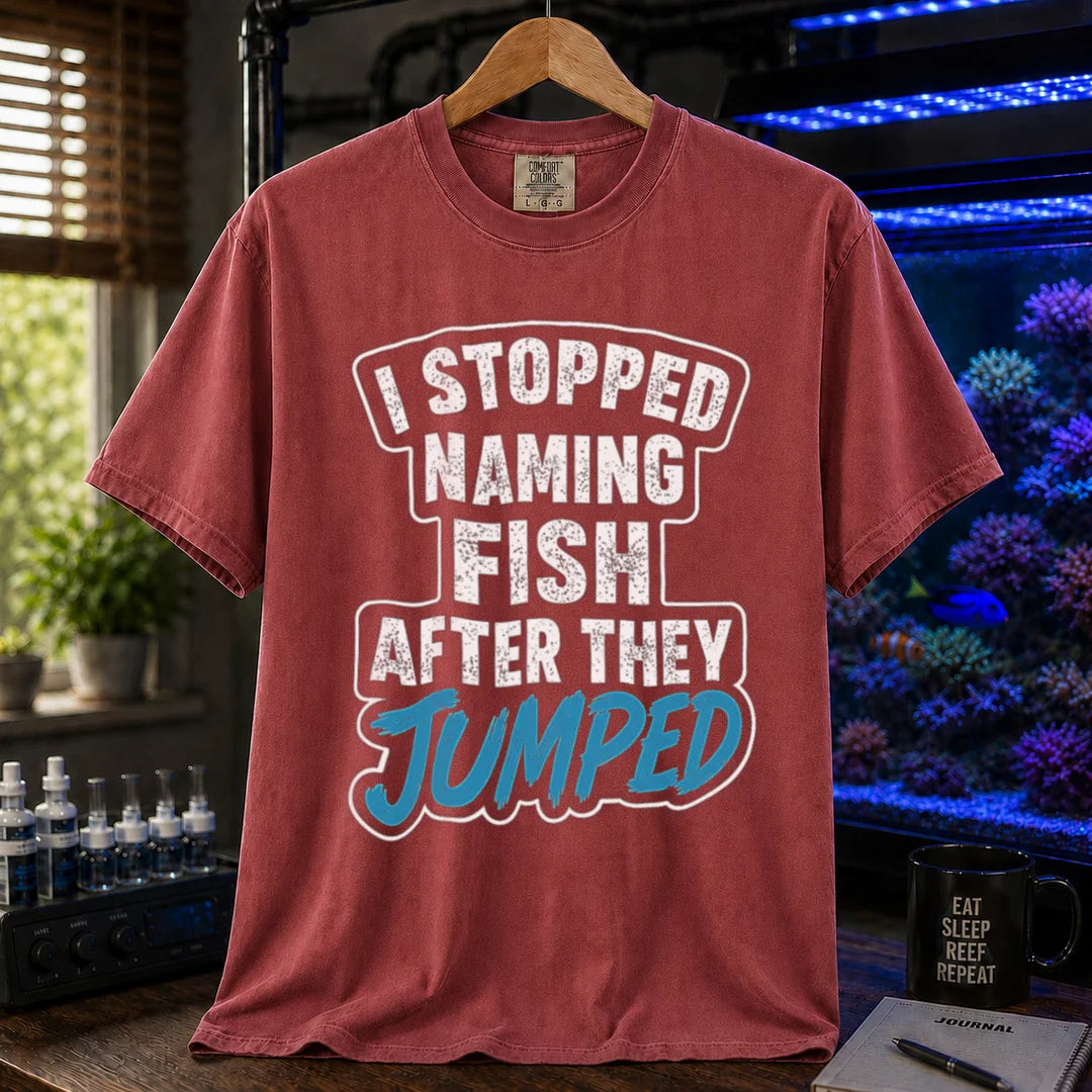 Saltwater aquarium graphic t-shirt featuring distressed block text and blue script: I STOPPED NAMING FISH AFTER THEY JUMPED, maroon, red crew neck tee