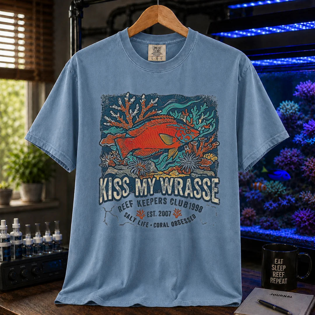 Saltwater aquarium graphic t-shirt featuring a wrasse and coral reef illustration with text: KISS MY WRASSE REEF KEEPERS CLUB, blue crew neck tee