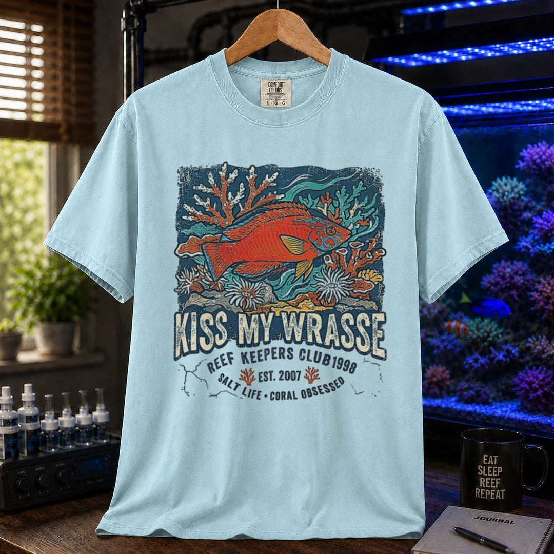 Saltwater aquarium graphic t-shirt featuring a wrasse and coral reef illustration with text: KISS MY WRASSE REEF KEEPERS CLUB, light blue crew neck tee