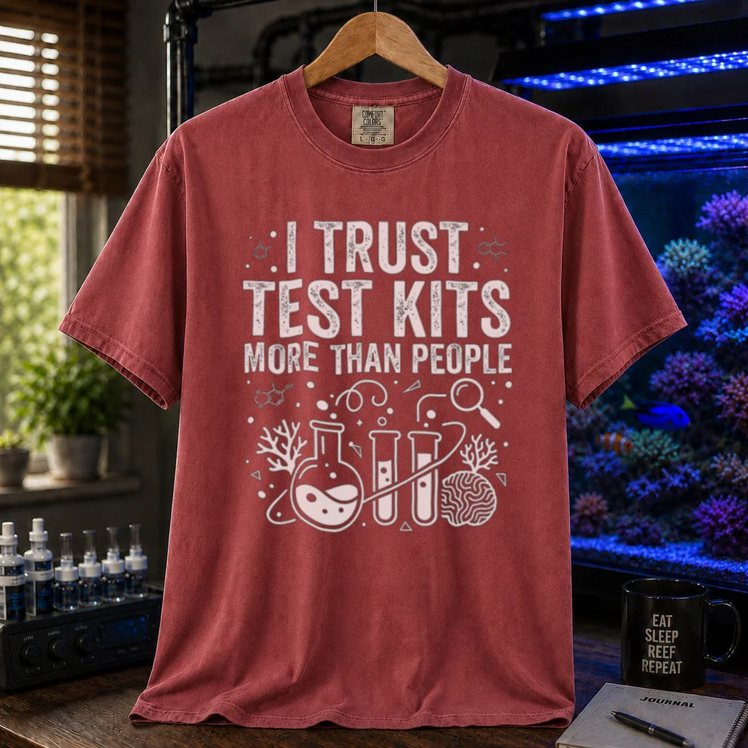 Saltwater aquarium graphic t-shirt featuring chemistry glassware and test tubes with text: I TRUST TEST KITS MORE THAN PEOPLE, maroon, red crew neck tee