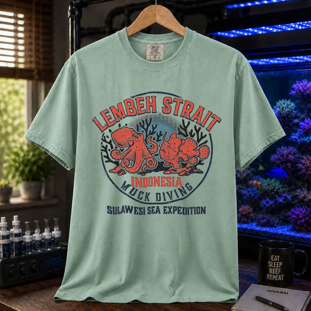 Saltwater aquarium graphic t-shirt featuring an octopus and frogfish illustration with text: LEMBEH STRAIT INDONESIA MUCK DIVING SULAWESI SEA EXPEDITION, green crew neck tee