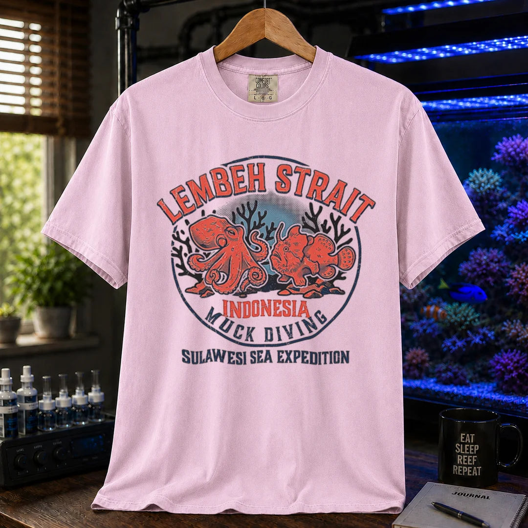 Saltwater aquarium graphic t-shirt featuring an octopus and frogfish illustration with text: LEMBEH STRAIT INDONESIA MUCK DIVING SULAWESI SEA EXPEDITION, pink crew neck tee