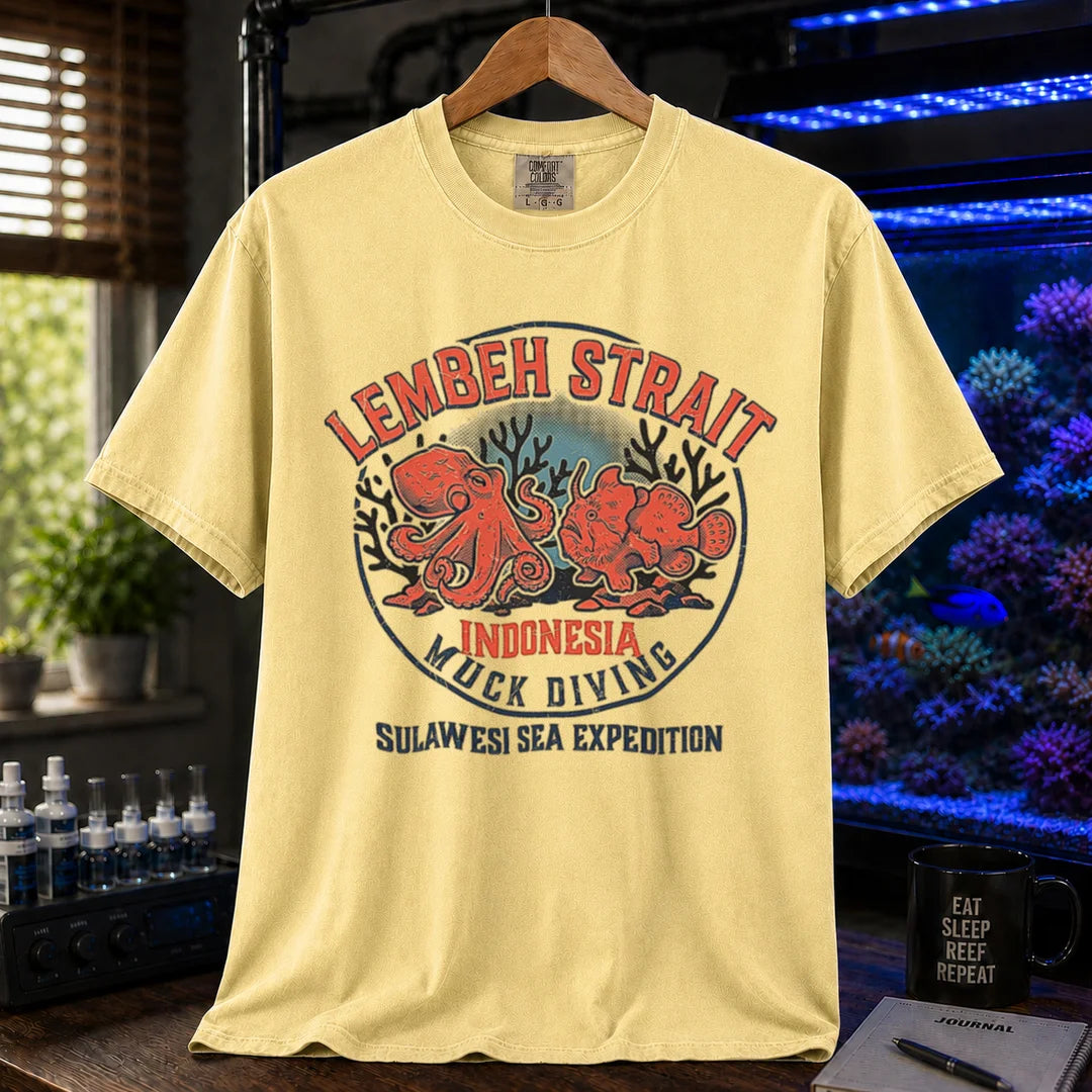 Saltwater aquarium graphic t-shirt featuring an octopus and frogfish illustration with text: LEMBEH STRAIT INDONESIA MUCK DIVING SULAWESI SEA EXPEDITION, yellow crew neck tee