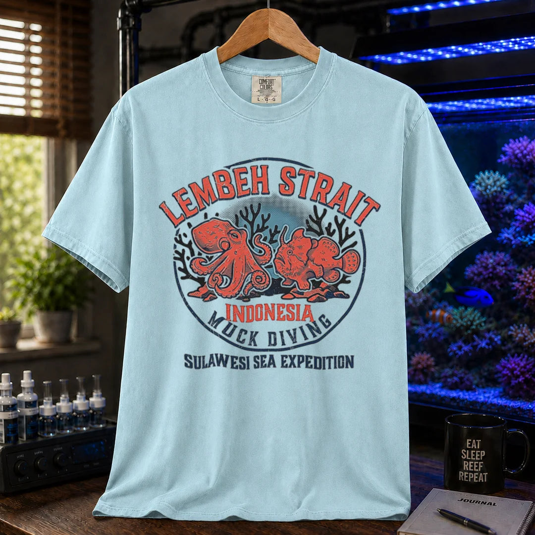 Saltwater aquarium graphic t-shirt featuring an octopus and frogfish illustration with text: LEMBEH STRAIT INDONESIA MUCK DIVING SULAWESI SEA EXPEDITION, blue crew neck tee