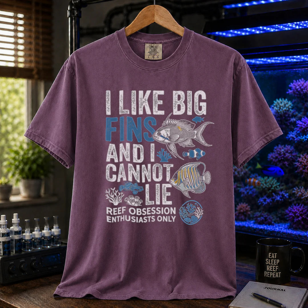 Saltwater aquarium graphic t-shirt featuring marine fish illustrations and text: I LIKE BIG FINS AND I CANNOT LIE REEF OBSESSION ENTHUSIASTS ONLY, purple crew neck tee