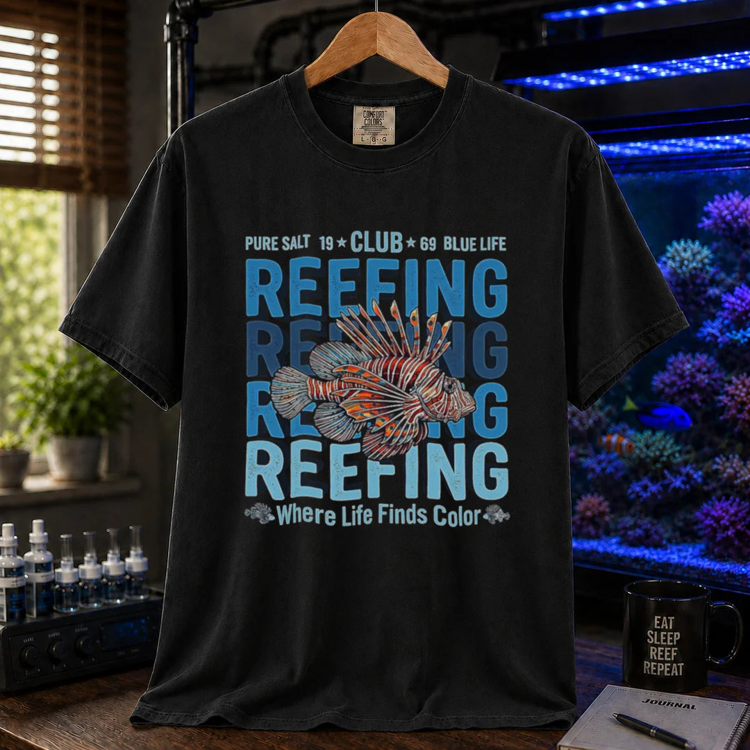 Saltwater aquarium graphic t-shirt featuring a lionfish illustration and repeated text: REEFING Where Life Finds Color, black crew neck tee