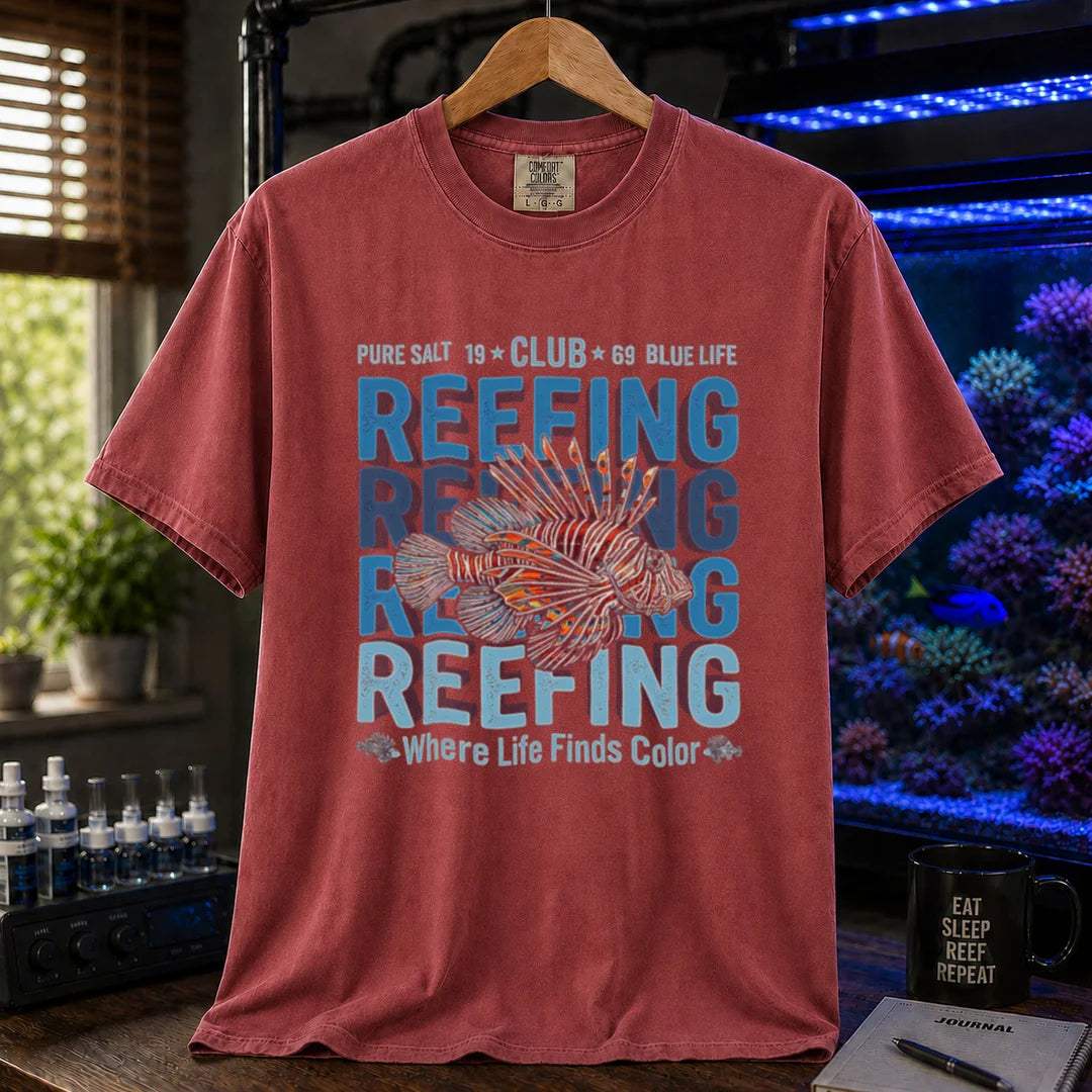 Saltwater aquarium graphic t-shirt featuring a lionfish illustration and repeated text: REEFING Where Life Finds Color, maroon, red crew neck tee