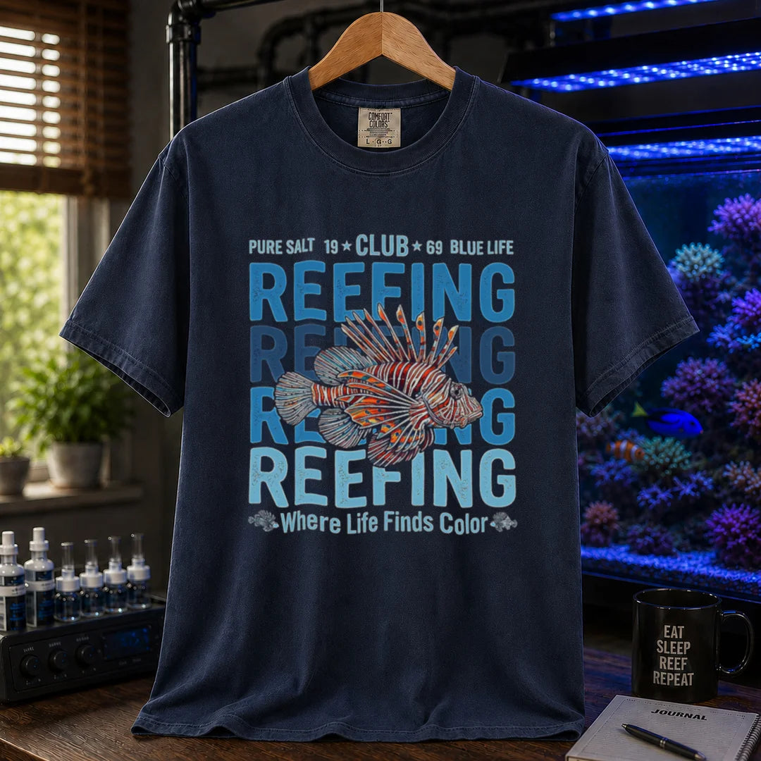 Saltwater aquarium graphic t-shirt featuring a lionfish illustration and repeated text: REEFING Where Life Finds Color, navy crew neck tee