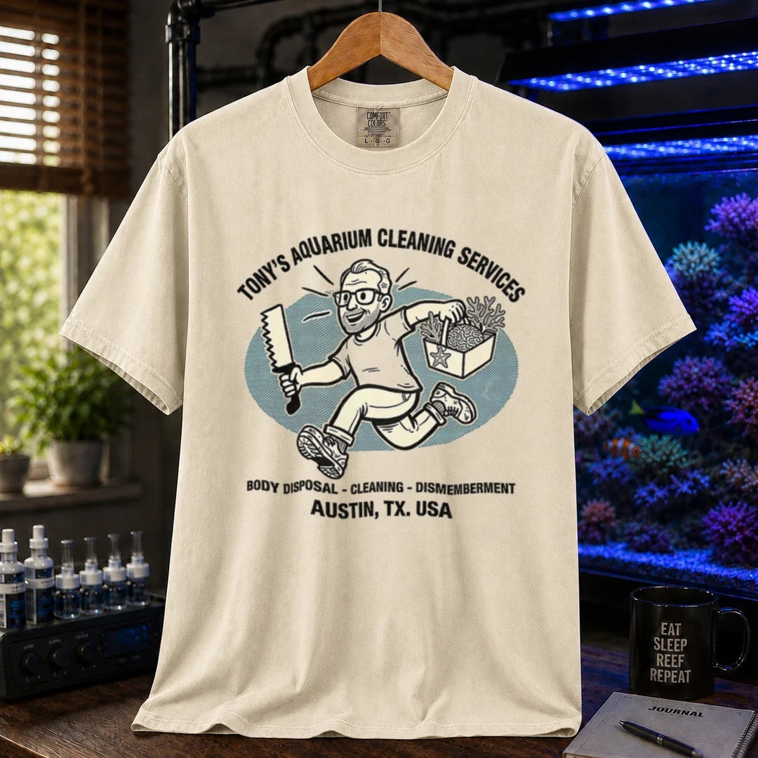Saltwater aquarium graphic t-shirt featuring a cartoon illustration and text: TONY'S AQUARIUM CLEANING SERVICES BODY DISPOSAL - CLEANING - DISMEMBERMENT AUSTIN, TX. USA, cream, beige, ivory crew neck tee