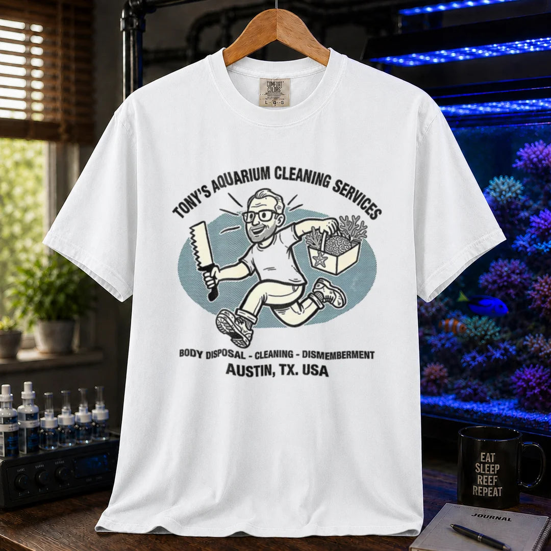 Saltwater aquarium graphic t-shirt featuring a cartoon illustration and text: TONY'S AQUARIUM CLEANING SERVICES BODY DISPOSAL - CLEANING - DISMEMBERMENT AUSTIN, TX. USA, white crew neck tee