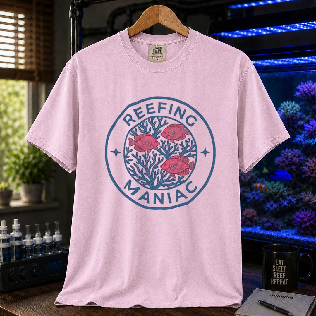 Saltwater aquarium graphic t-shirt featuring a circular coral and fish emblem with text: REEFING MANIAC, pink crew neck tee