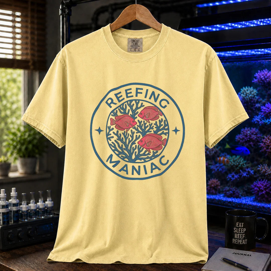 Saltwater aquarium graphic t-shirt featuring a circular coral and fish emblem with text: REEFING MANIAC, yellow crew neck tee