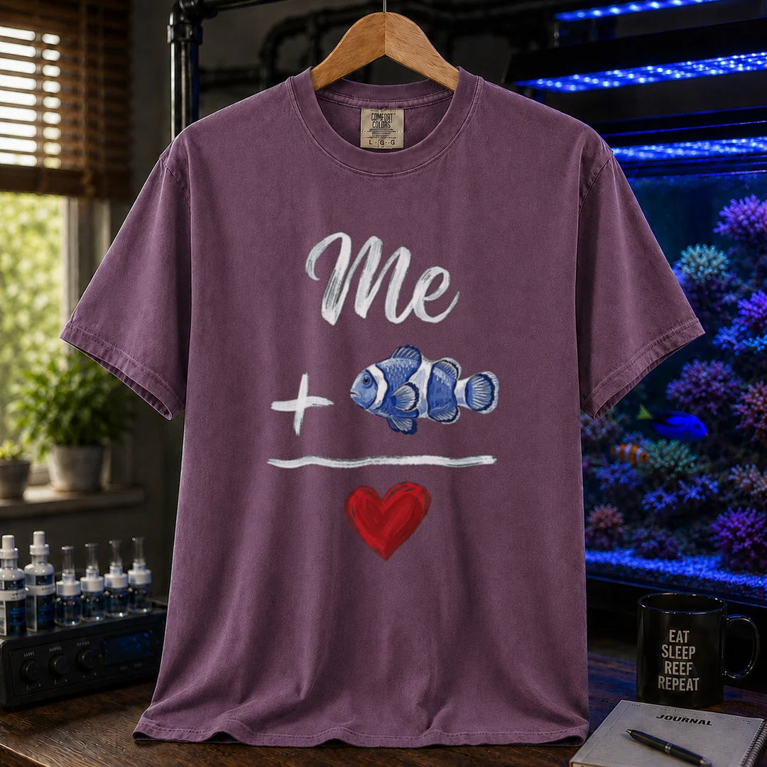 Saltwater aquarium graphic t-shirt featuring a hand-drawn math equation with text and art: Me + [Clownfish Illustration] = [Red Heart], purple crew neck tee