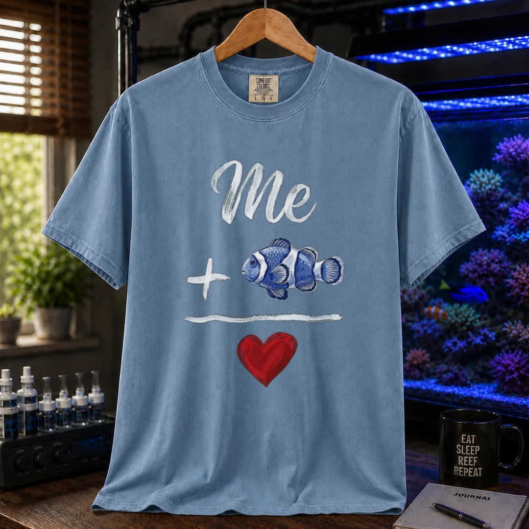 Saltwater aquarium graphic t-shirt featuring a hand-drawn math equation with text and art: Me + [Clownfish Illustration] = [Red Heart], blue crew neck tee