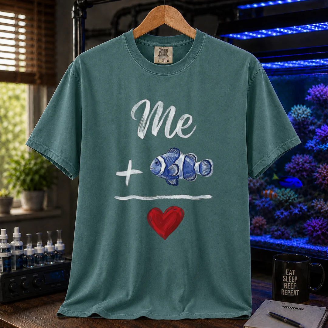 Saltwater aquarium graphic t-shirt featuring a hand-drawn math equation with text and art: Me + [Clownfish Illustration] = [Red Heart], green crew neck tee
