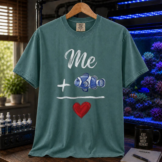 Saltwater aquarium graphic t-shirt featuring a hand-drawn math equation with text and art: Me + [Clownfish Illustration] = [Red Heart], green crew neck tee