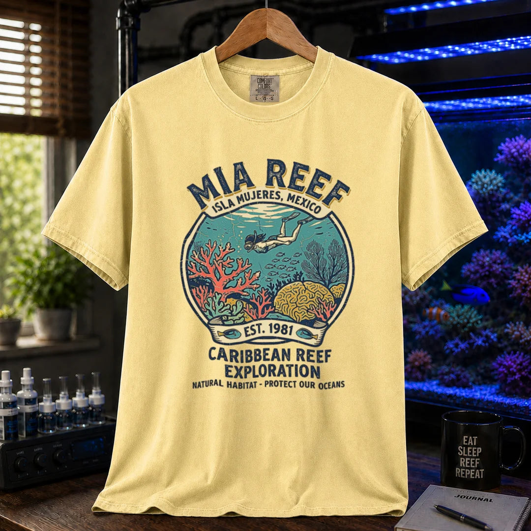 Saltwater aquarium graphic t-shirt featuring a circular diver and coral reef emblem with text: MIA REEF ISLA MUJERES, MEXICO CARIBBEAN REEF EXPLORATION NATURAL HABITAT - PROTECT OUR OCEANS, yellow crew neck tee