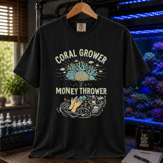 Saltwater aquarium graphic t-shirt featuring a two-part illustration of corals above and hands throwing cash into a gear whirlpool below with text: CORAL GROWER MONEY THROWER, black crew neck tee
