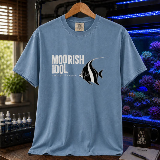 Saltwater aquarium graphic t-shirt featuring a Moorish Idol fish illustration and text: MOORISH IDOL ZANCLUS CORNUTUS, blue crew neck tee