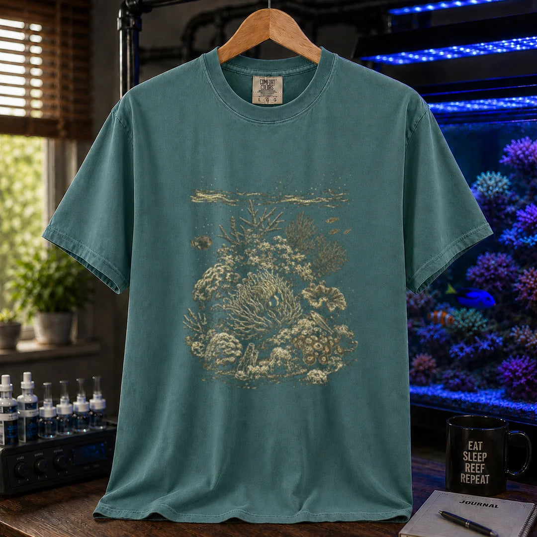 Saltwater aquarium graphic t-shirt featuring a detailed vintage scientific engraving of a coral reef ecosystem, green crew neck tee