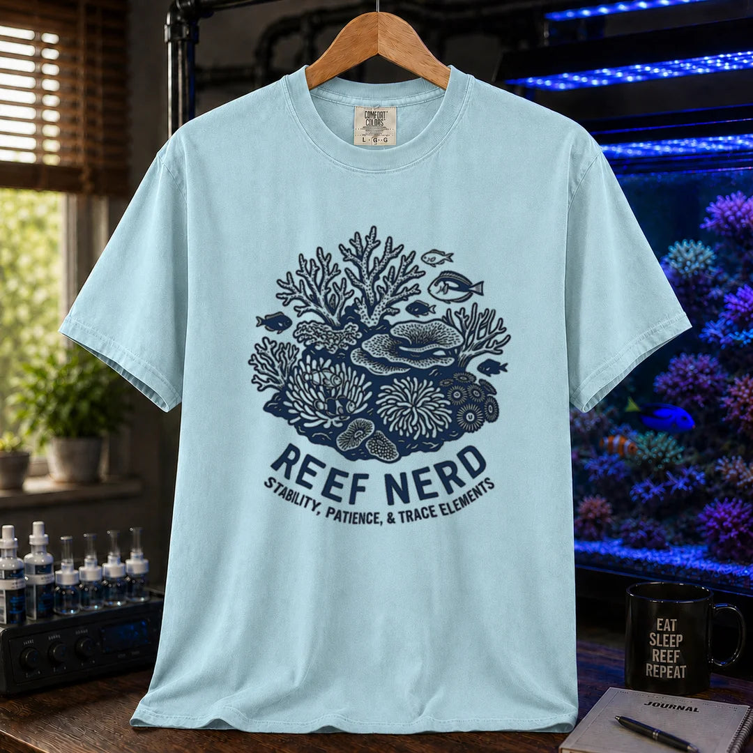 Saltwater aquarium graphic t-shirt featuring a detailed coral reef illustration with text: REEF NERD STABILITY, PATIENCE, & TRACE ELEMENTS, light blue crew neck tee