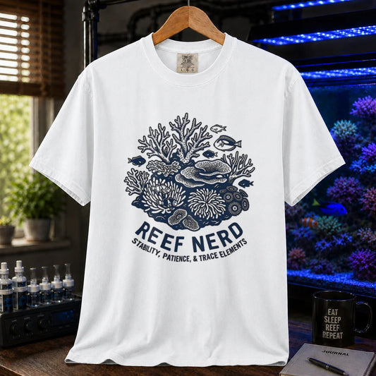Saltwater aquarium graphic t-shirt featuring a detailed coral reef illustration with text: REEF NERD STABILITY, PATIENCE, & TRACE ELEMENTS, white crew neck tee