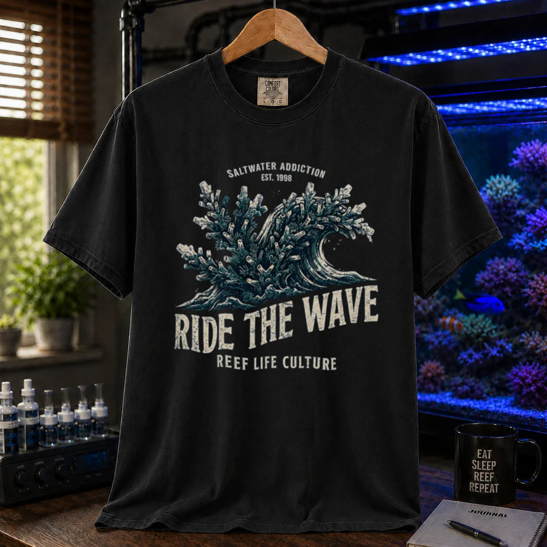 Saltwater aquarium graphic t-shirt featuring a vintage ocean wave made of coral and text: SALTWATER ADDICTION RIDE THE WAVE REEF LIFE CULTURE, black crew neck tee