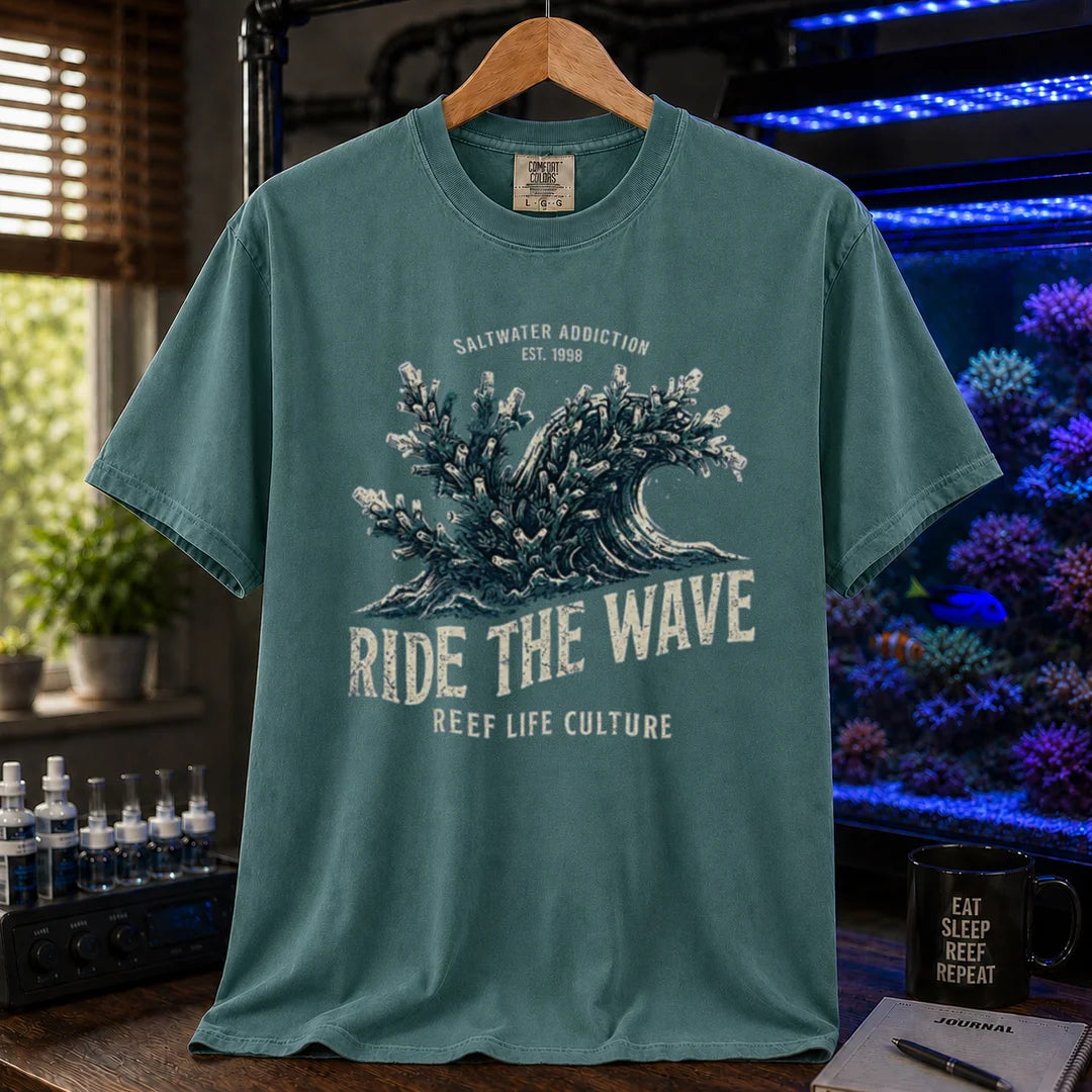 Saltwater aquarium graphic t-shirt featuring a vintage ocean wave made of coral and text: SALTWATER ADDICTION RIDE THE WAVE REEF LIFE CULTURE, green crew neck tee