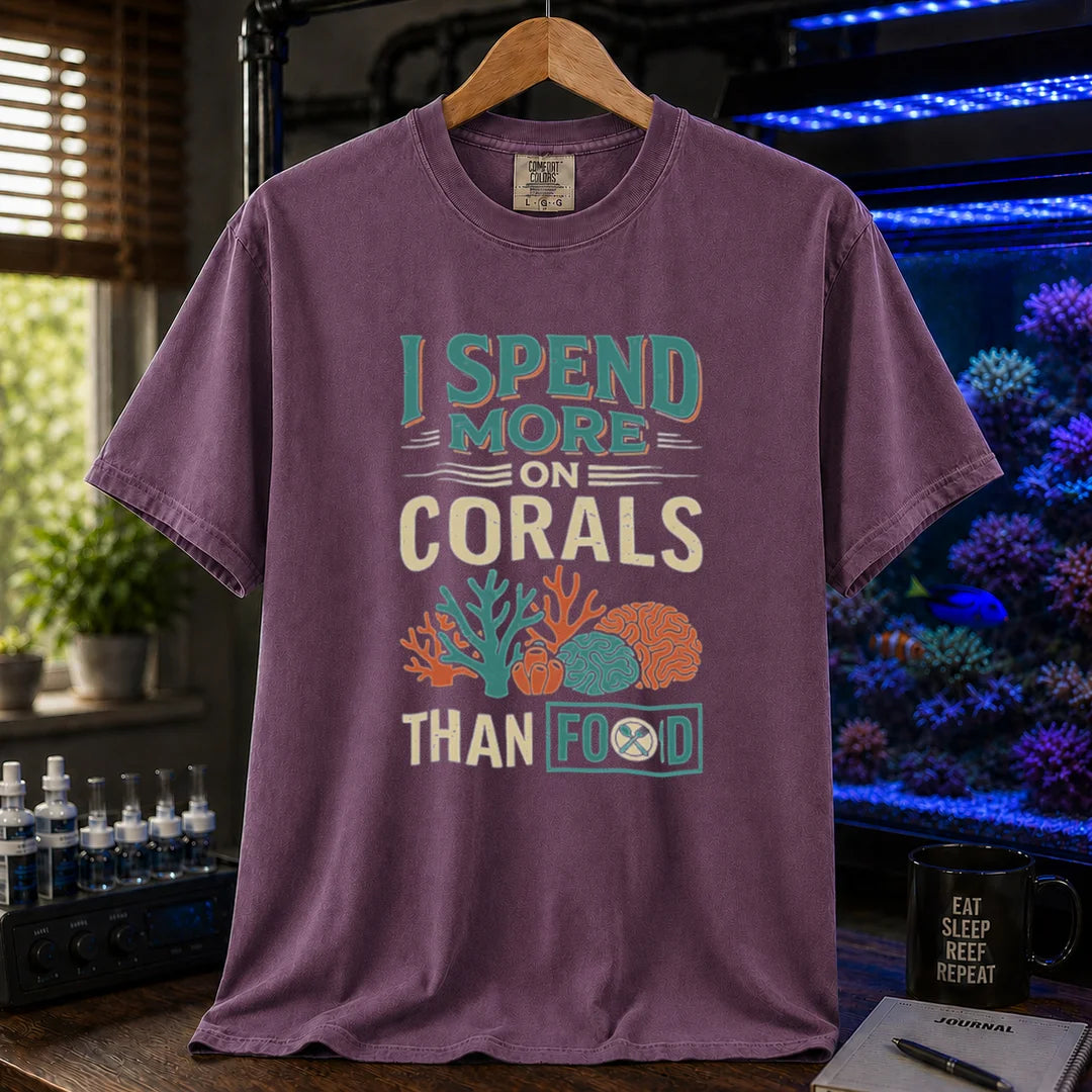 Saltwater aquarium graphic t-shirt featuring a colorful coral illustration and text: I SPEND MORE ON CORALS THAN FOOD, purple crew neck tee