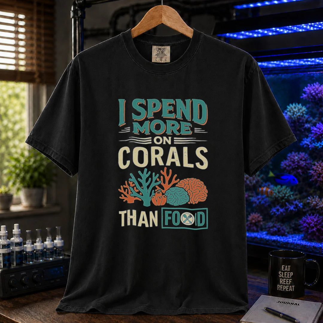 Saltwater aquarium graphic t-shirt featuring a colorful coral illustration and text: I SPEND MORE ON CORALS THAN FOOD, black crew neck tee