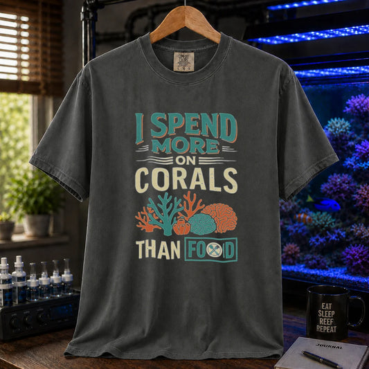 Saltwater aquarium graphic t-shirt featuring a colorful coral illustration and text: I SPEND MORE ON CORALS THAN FOOD, dark grey crew neck tee