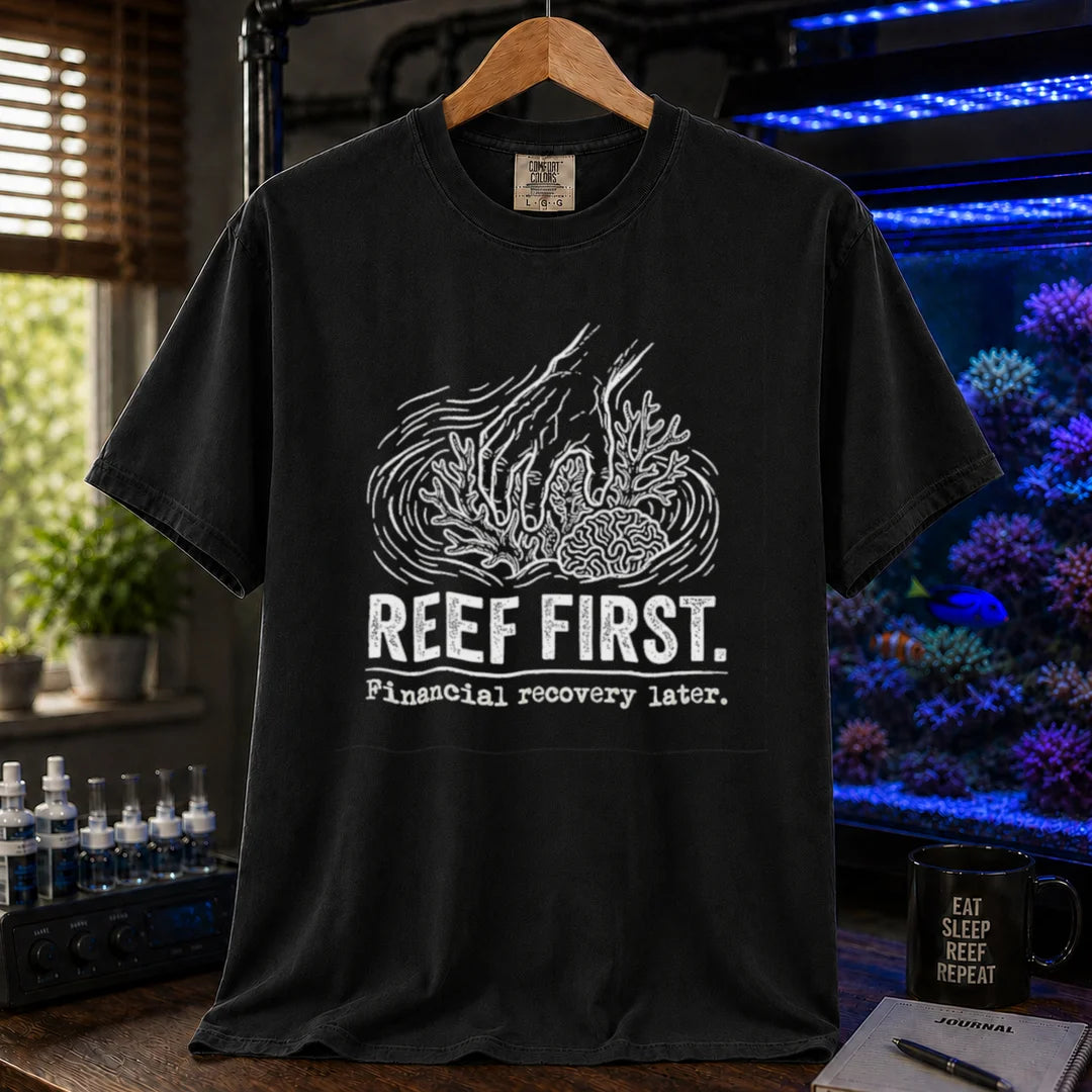 Saltwater aquarium graphic t-shirt featuring a hand tending corals illustration and text: REEF FIRST. Financial recovery later., black crew neck tee