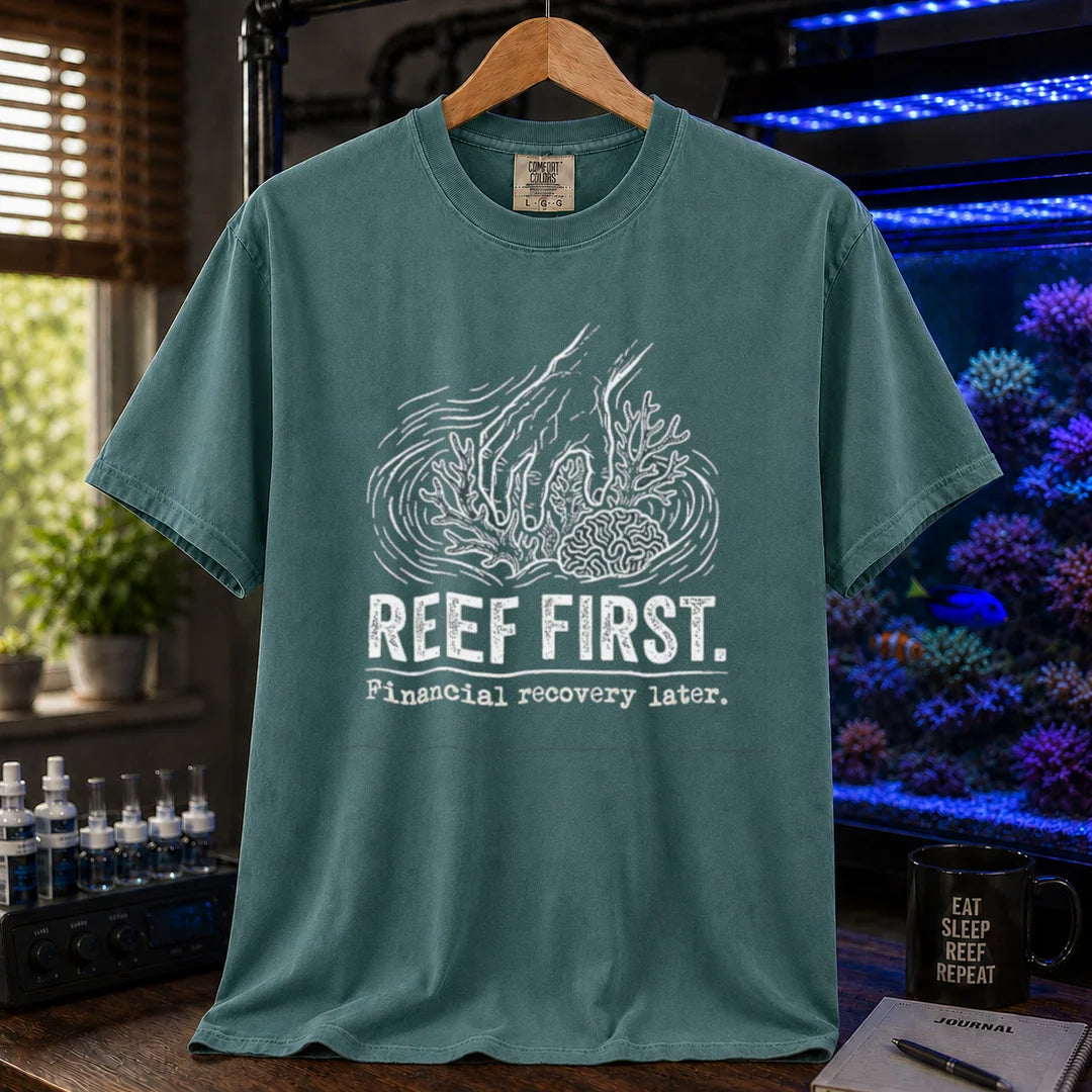 Saltwater aquarium graphic t-shirt featuring a hand tending corals illustration and text: REEF FIRST. Financial recovery later., green crew neck tee