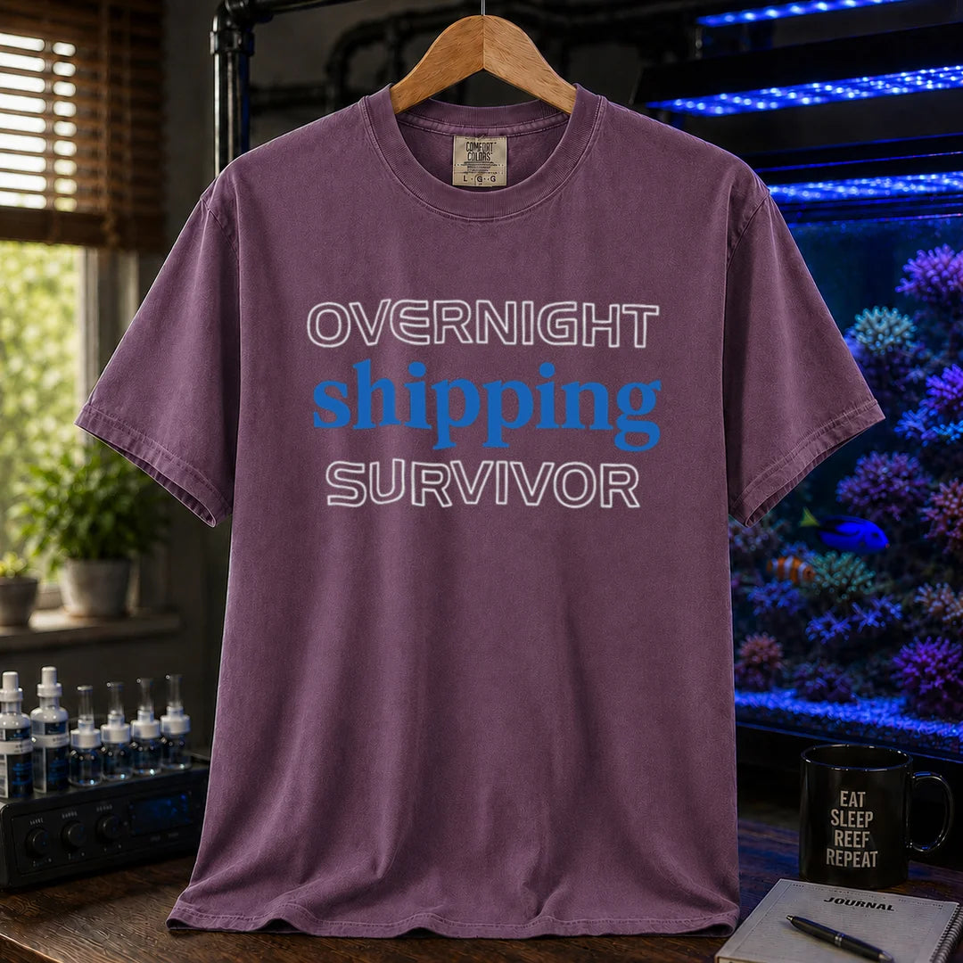 Saltwater aquarium graphic t-shirt featuring outline and solid text: OVERNIGHT shipping SURVIVOR, purple crew neck tee