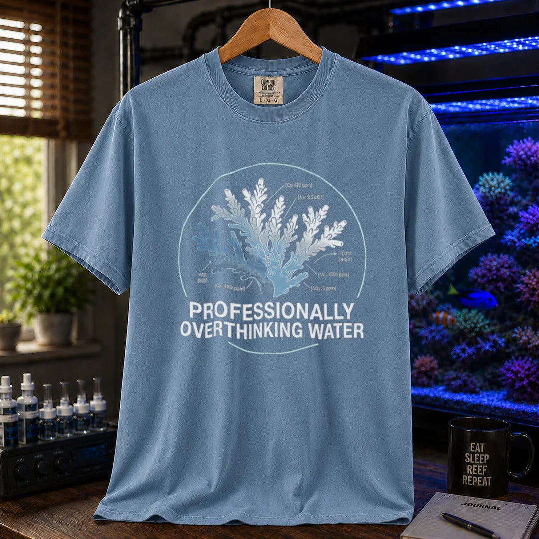 Saltwater aquarium graphic t-shirt featuring a scientific coral diagram with water parameters and text: PROFESSIONALLY OVERTHINKING WATER, blue crew neck tee