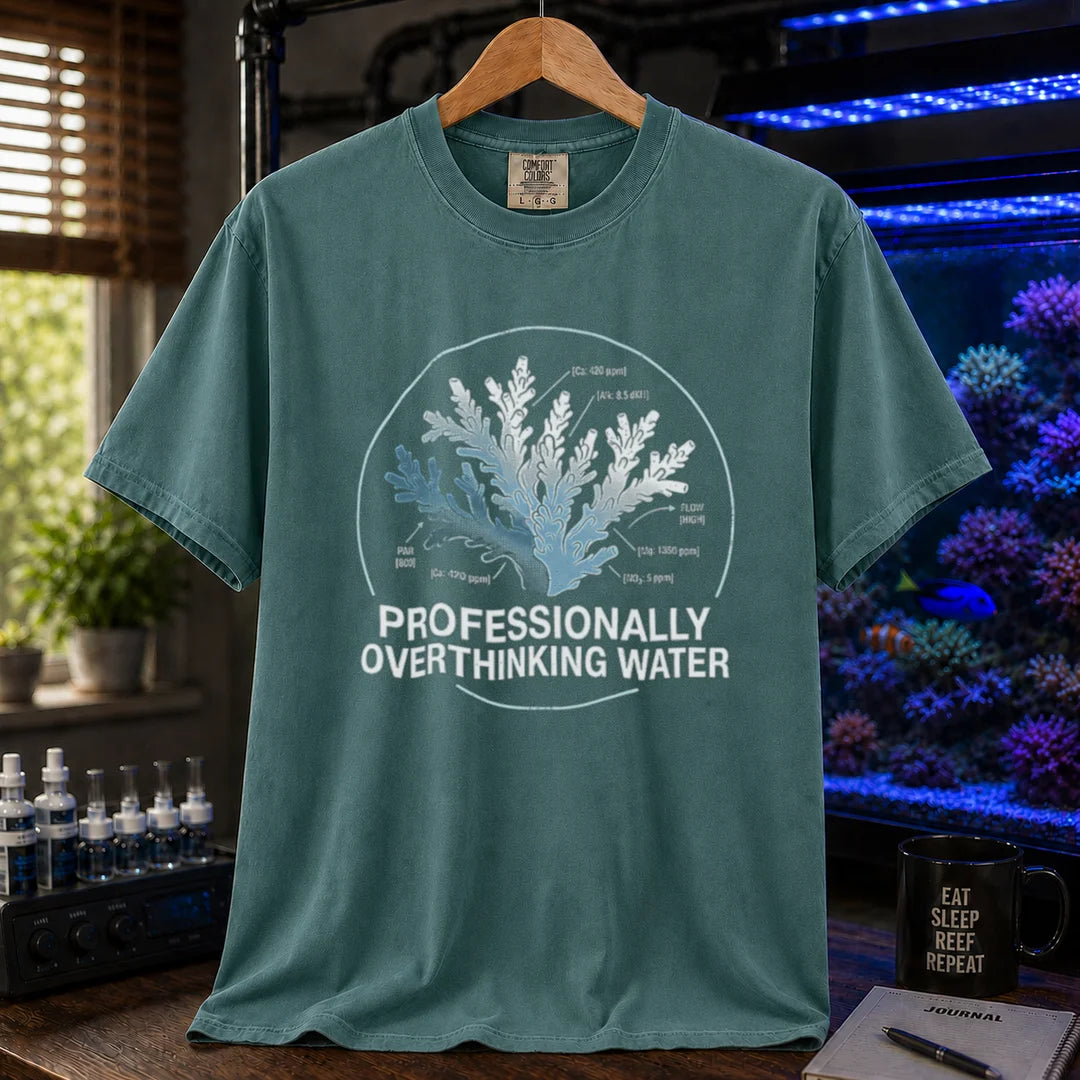 Saltwater aquarium graphic t-shirt featuring a scientific coral diagram with water parameters and text: PROFESSIONALLY OVERTHINKING WATER, green crew neck tee