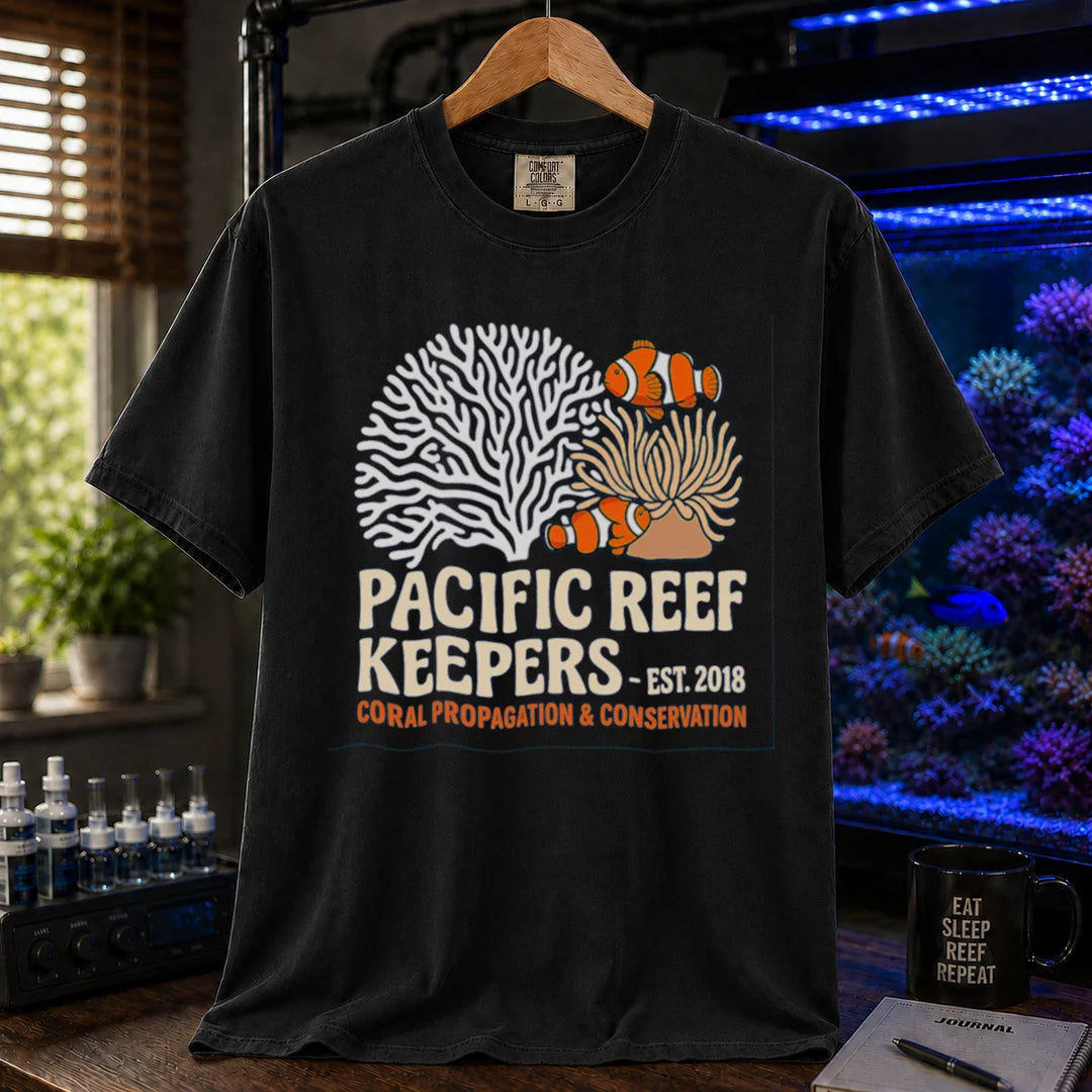 Saltwater aquarium graphic t-shirt featuring clownfish, anemone, and coral illustrations with text: PACIFIC REEF KEEPERS - EST. 2018 SUSTAINABLE REEFKEEPING, black crew neck tee