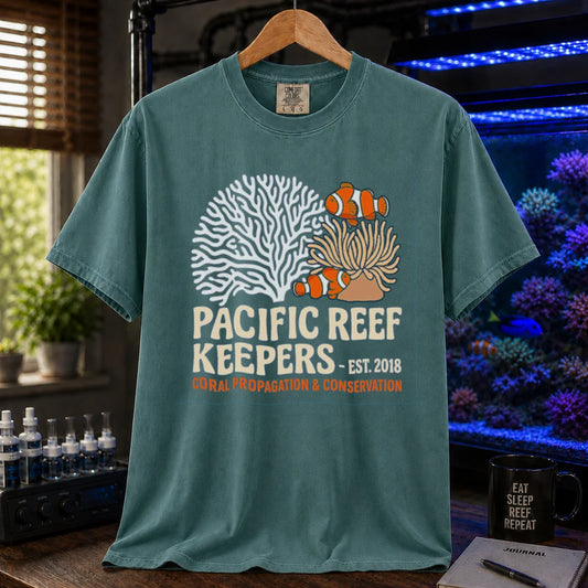 Saltwater aquarium graphic t-shirt featuring clownfish, anemone, and coral illustrations with text: PACIFIC REEF KEEPERS - EST. 2018 SUSTAINABLE REEFKEEPING, green crew neck tee