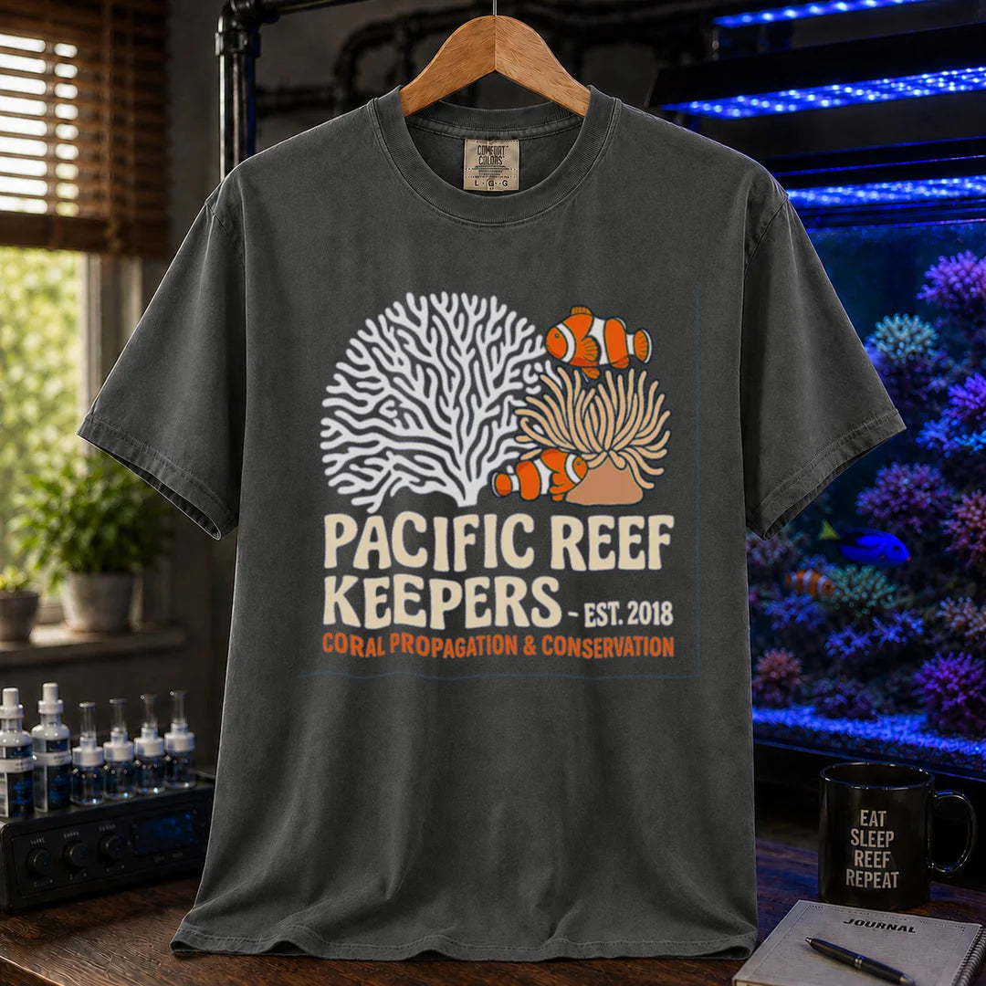 Saltwater aquarium graphic t-shirt featuring clownfish, anemone, and coral illustrations with text: PACIFIC REEF KEEPERS - EST. 2018 SUSTAINABLE REEFKEEPING, dark grey crew neck tee