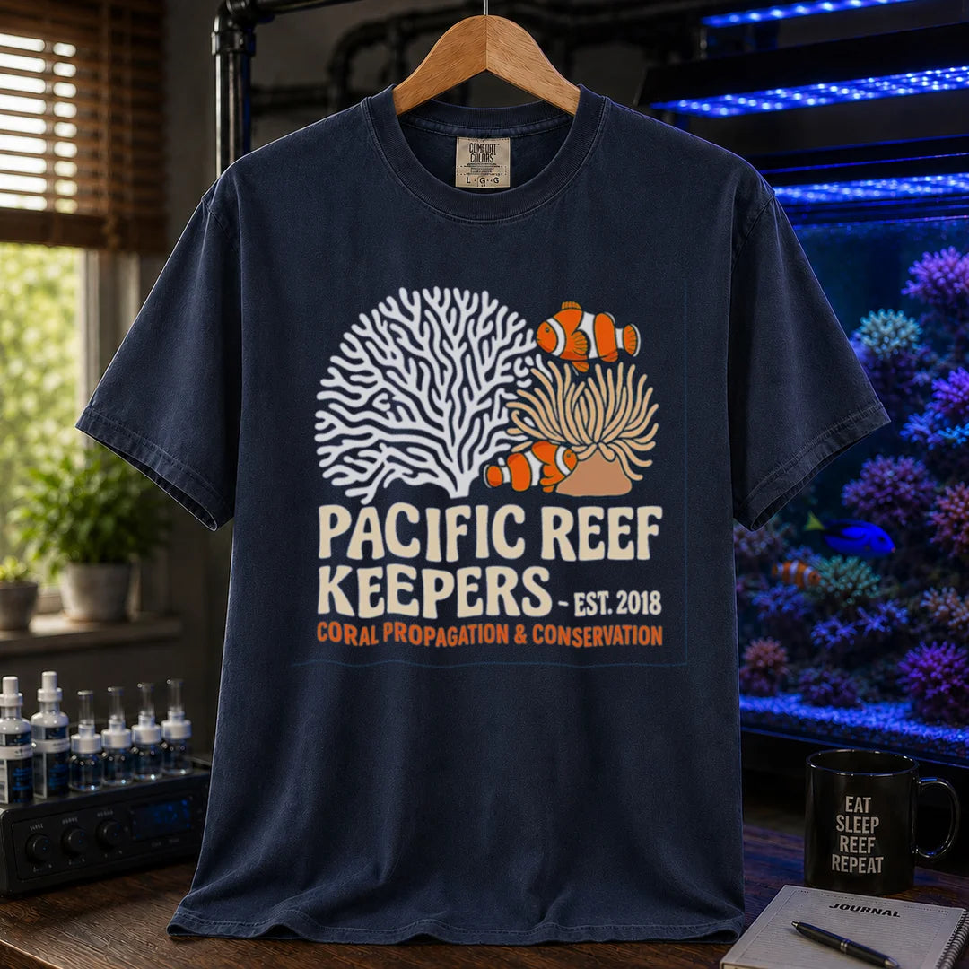 Saltwater aquarium graphic t-shirt featuring clownfish, anemone, and coral illustrations with text: PACIFIC REEF KEEPERS - EST. 2018 SUSTAINABLE REEFKEEPING, navy crew neck tee