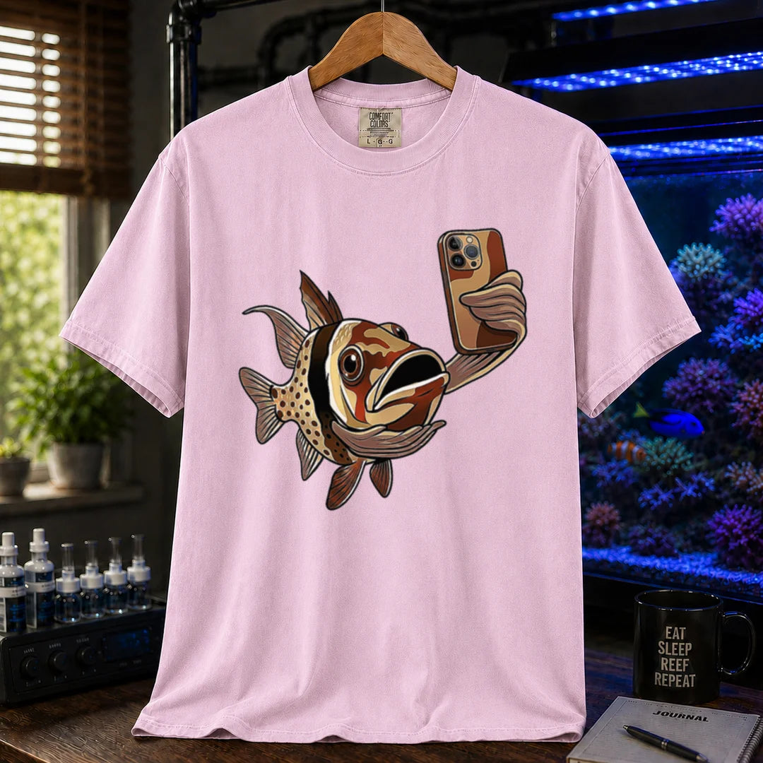 Saltwater aquarium graphic t-shirt featuring a pajama cardinalfish taking a selfie with a smartphone, pink crew neck tee