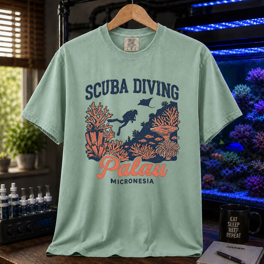 Saltwater aquarium graphic t-shirt featuring a scuba diver and coral reef illustration with text: SCUBA DIVING Palau MICRONESIA, green crew neck tee
