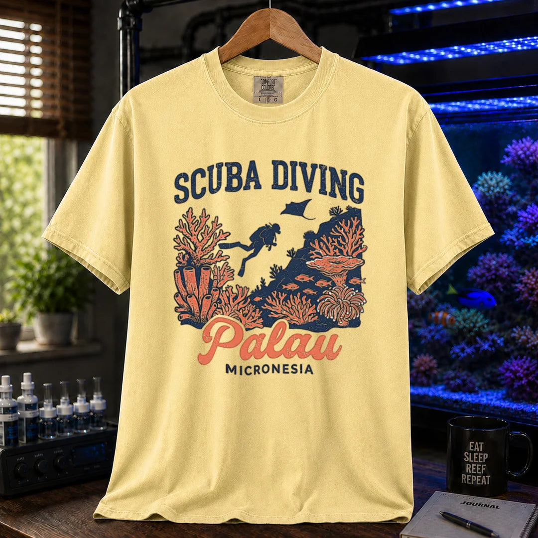 Saltwater aquarium graphic t-shirt featuring a scuba diver and coral reef illustration with text: SCUBA DIVING Palau MICRONESIA, yellow crew neck tee