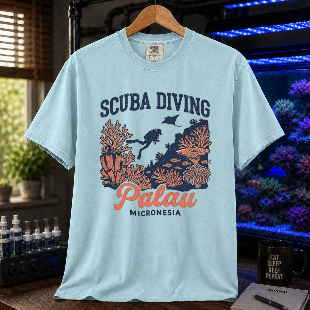 Saltwater aquarium graphic t-shirt featuring a scuba diver and coral reef illustration with text: SCUBA DIVING Palau MICRONESIA, blue crew neck tee