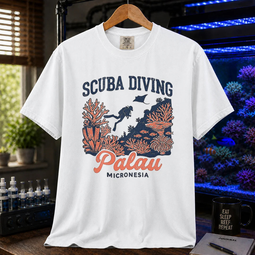 Saltwater aquarium graphic t-shirt featuring a scuba diver and coral reef illustration with text: SCUBA DIVING Palau MICRONESIA, white crew neck tee