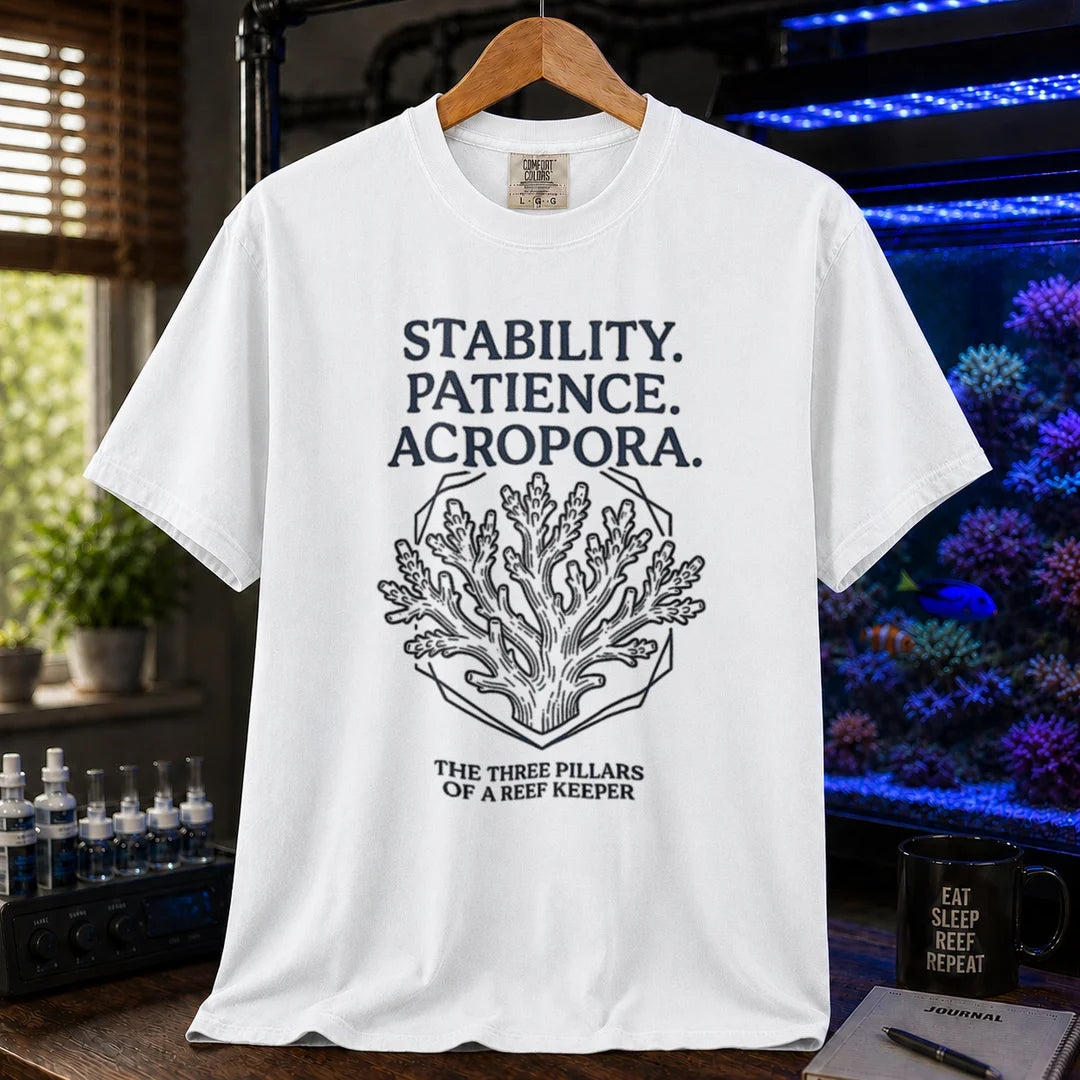Saltwater aquarium graphic t-shirt featuring an Acropora coral illustration and text: STABILITY. PATIENCE. ACROPORA. THE THREE PILLARS OF A REEF KEEPER, white crew neck tee