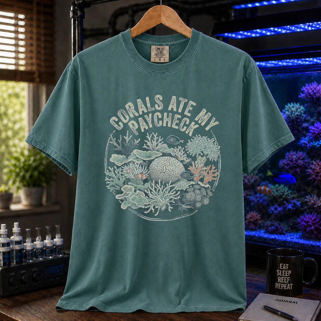 Saltwater aquarium graphic t-shirt featuring a circular coral reef illustration and text: CORALS ATE MY PAYCHECK, green crew neck tee
