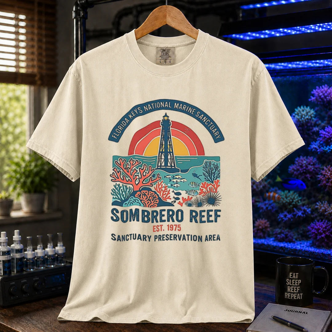 Saltwater aquarium graphic t-shirt featuring a lighthouse and coral reef illustration with text: FLORIDA KEYS NATIONAL MARINE SANCTUARY SOMBRERO REEF EST. 1975 SANCTUARY PRESERVATION AREA, cream, beige, ivory crew neck tee