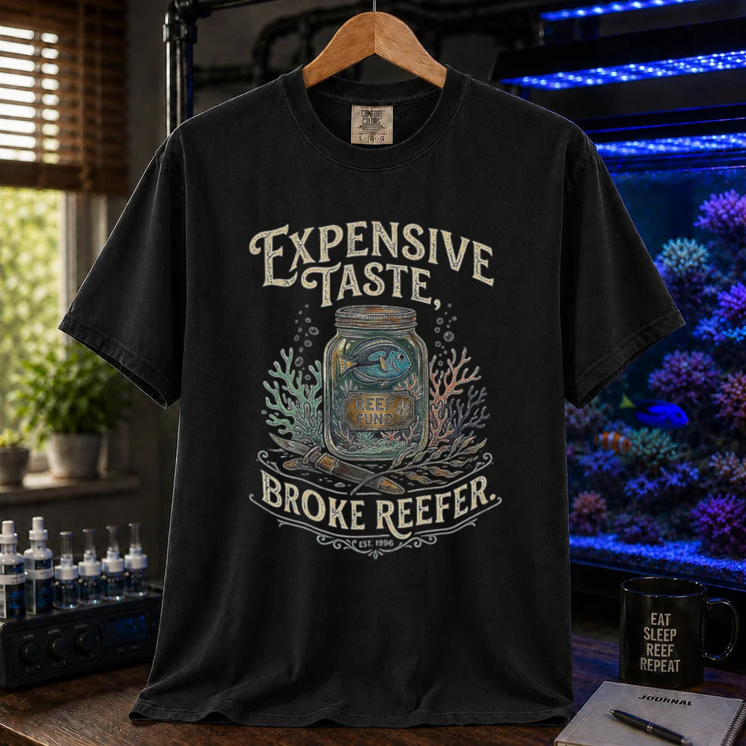 Saltwater aquarium graphic t-shirt featuring a reef fund jar illustration and text: EXPENSIVE TASTE, BROKE REEFER., black crew neck tee